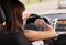 Woman driving a car and looking at watch