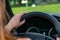 Woman driving car, visible speedometer screen and beautiful natural green scenery