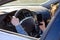 Woman driving her car as she reads an sms