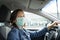 Woman driving her car with a mask