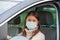 Woman driving in mask during   covid 19 pandemic