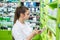 Woman druggist looking for medicaments in drugstore