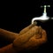 Woman dry cracking hands under faucet