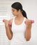 Woman, dumbbell and home fitness with workout, wellness and exercise in living room with weights. Health, Indian female