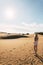 Woman in the dunes desert in a sunny day