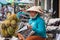 Woman durian vendor reading a newspaper