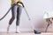 Woman dusting dirty apartment