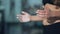 Woman dusting his hands with chalk powder in gym. Close up Handheld slowmotion