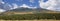 A Woman is Dwarfed by the San Francisco Peaks