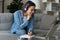 Woman e-learn use laptop listen audio course through wireless headphones