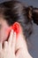 Woman with earache, ear pain on gray background