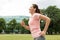 Woman with earphones running at park