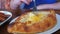 Woman Eating Adjarian Khachapuri with a Fork in a Georgian Restaurant on a Wooden Table. Georgian Food