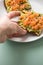 Woman eating avocado smoked salmon on sunflower seed whole grain bread slice with sesame seeds for breakfast or snack on mint