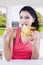 Woman eating banana with autumn background