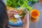 Woman eating Banh Xeo, Vietnamese crusty prawn crepe with vegetables