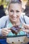 Woman eating barbecue pork ribs at an outdoor eatery