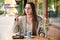 Woman eating a cake and drinking coffee in a cafe.