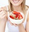 Woman eating cereals with strawberries