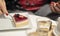 Woman eating cheesecake and drinking coffee in a cafe. Cheese cake slice with strawberry and blackberry.