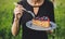 Woman eating a chocolate covered blueberry and raspberry pice of cake