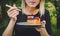 Woman eating a chocolate covered blueberry and raspberry pice of cake