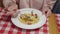 A woman eating delicious pumpkin pasta with shrimp and eats it in a restaurant of Italian cuisine.