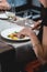 Woman eating delicious roulade of rabbit meat in a restaurant. small portion