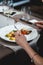 Woman eating delicious roulade of rabbit meat in a restaurant. small portion