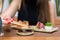 Woman eating delicious sushi, closeup on chopsticks