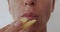 Woman eating french fries, unhealthy eating, close-up lips.