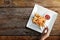 Woman Eating French Potato Fries, Serve on Metal Mesh Flying Sieve with Two Dipping Sauce. Lay on Wooden Table