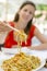 Woman eating fried noodles