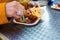 Woman eating German Currywurst at stand