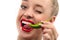 Woman eating green vegetable raw pepper