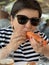 Woman Eating Huge Langoustine In Food Court Of A Seafood Market In Trouville, France