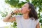 Woman eating ice cream, on a hot summer day. She closed her eyes and eagerly nibbles on the refreshing, delicious