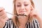 Woman eating insects with a fork in a restaurant