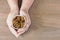 Woman eating Insects Silkworm Pupae Bombyx Mori. Her hand holding disposable cup which containing worm snack deep-fried for take