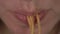 Woman eating instant noodles macro shot