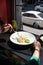 Woman eating italian pasta sitting at the cafe counter looking to the window, having lunch