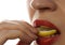 Woman eating juicy lemon, close-up lips on a white background.