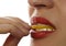 Woman eating juicy lemon, close-up lips on a white background.