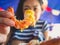 Woman eating local grilled seafood of Thailand beach.