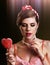 Woman eating lollipops. Girl in pin-up style hold striped candy.