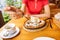 Woman eating manti or dumplings with white sauce in restaurant. Traditional cuisine of Oriental and Turkic people