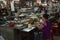 Woman eating in a market restaurant. Many small dishes with plenty of food