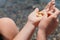 Woman eating milky almond nuts. A young caucasian woman chopping fresh green almond after morning fitness yoga near sea