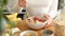 Woman eating oatmeal porridge with berries for breakfast