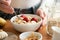 Woman eating oatmeal porridge with fruits